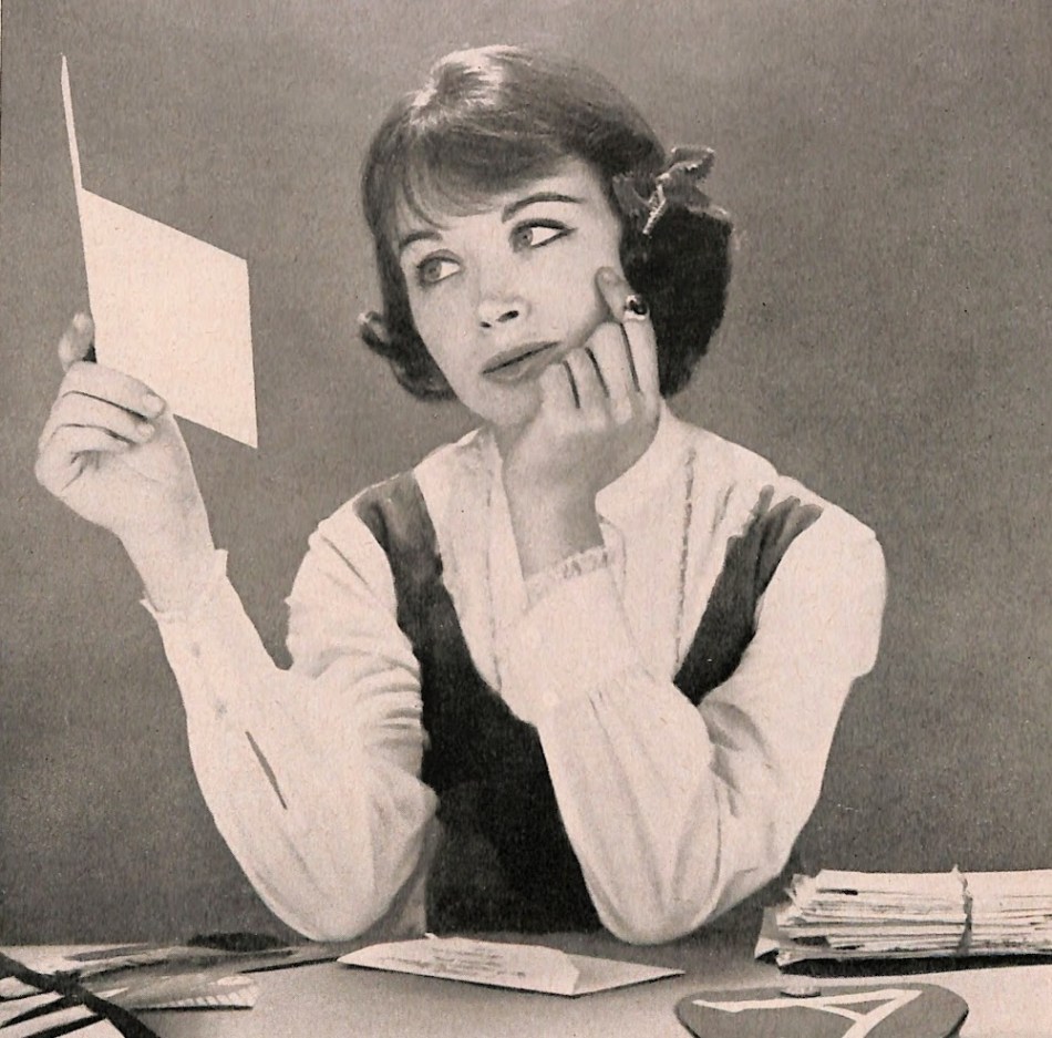 Teenager looking sadly at notecard.