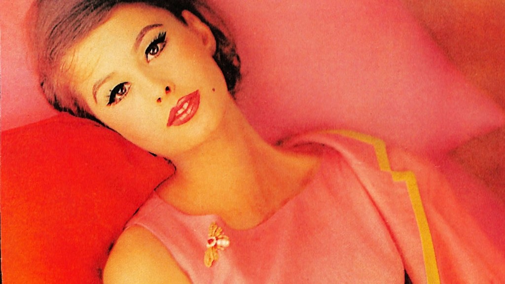 Woman dressed in pink lounging on pink pillows