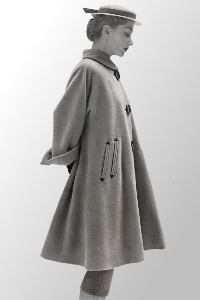 Side view of woman hat and 1950s full coat