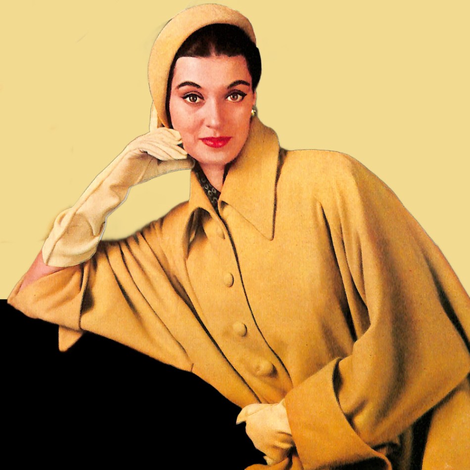 Stylish 1950s woman wearing gold coat, hat, and gloves.