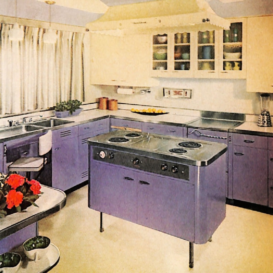 Vintage kitchen with lavender cabinets and center island stovetop.